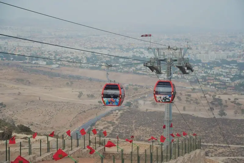 Red cable-car cabins of the Agadir téléphérique climbing towards the kasbah hill