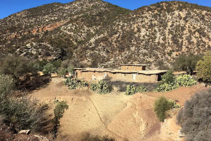 A traditional stone-and-earth house on a hillside in the valleys above Agadir