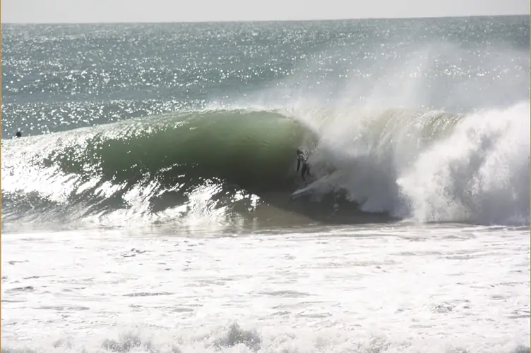 Surfer riding inside a breaking wave at Taghazout